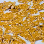 Old-Fashioned Peanut Brittle - A deliciously sweet, crunchy candy loaded with salty peanuts that's sure to please. Great for Christmas gifts, holiday candy trays, or all year long sweet.