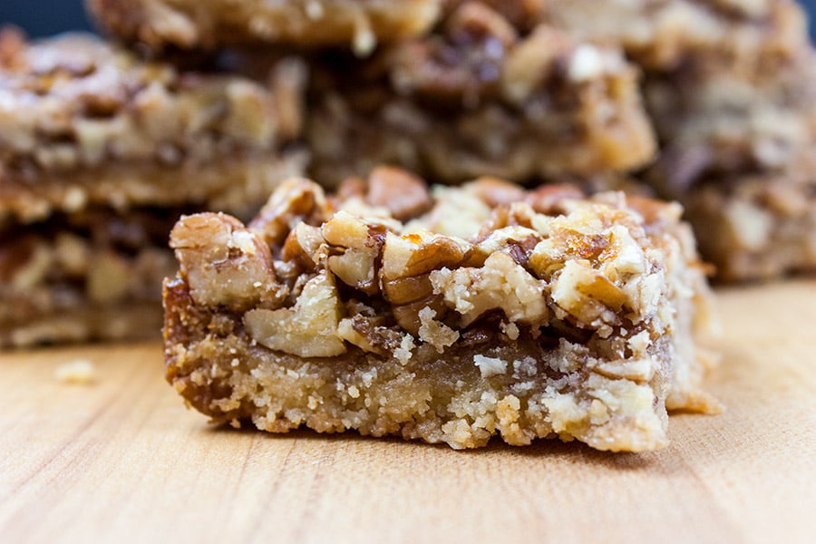 Pecan Pie Bars - A yummy shortbread crust topped with a buttery, nutty pecan pie layer! Warning: HIGHLY addictive!