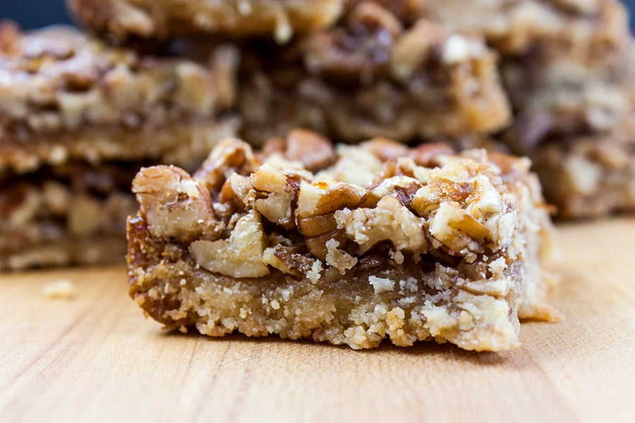 Pecan Pie Bars on a wooden cutting board.