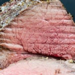 Garlic Herb Beef Top Round Roast sliced so you can see the pink center.
