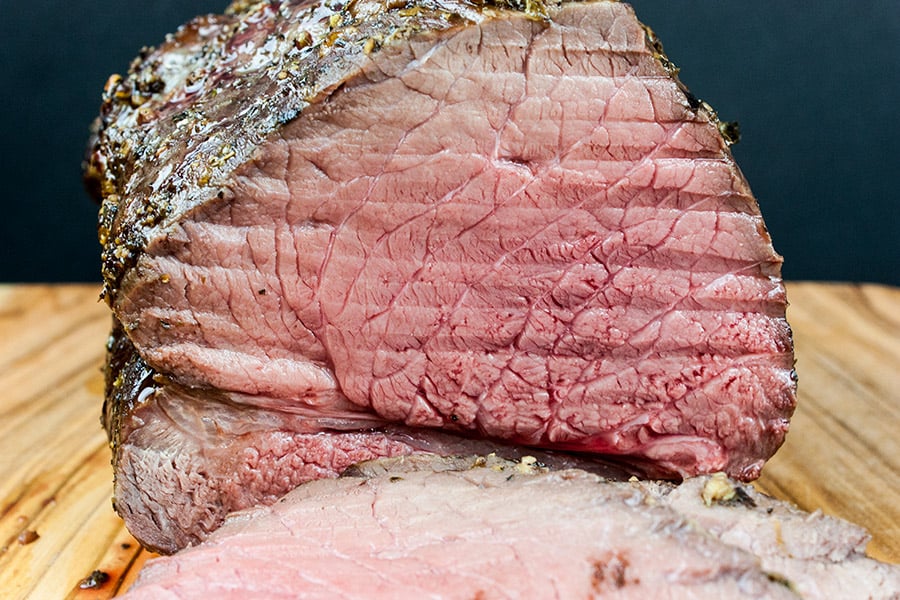 Garlic Herb Beef Top Round Roast sliced so you can see the pink center.