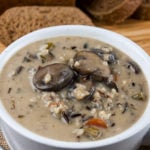 Wild rice and mushroom soup in a white bowl.