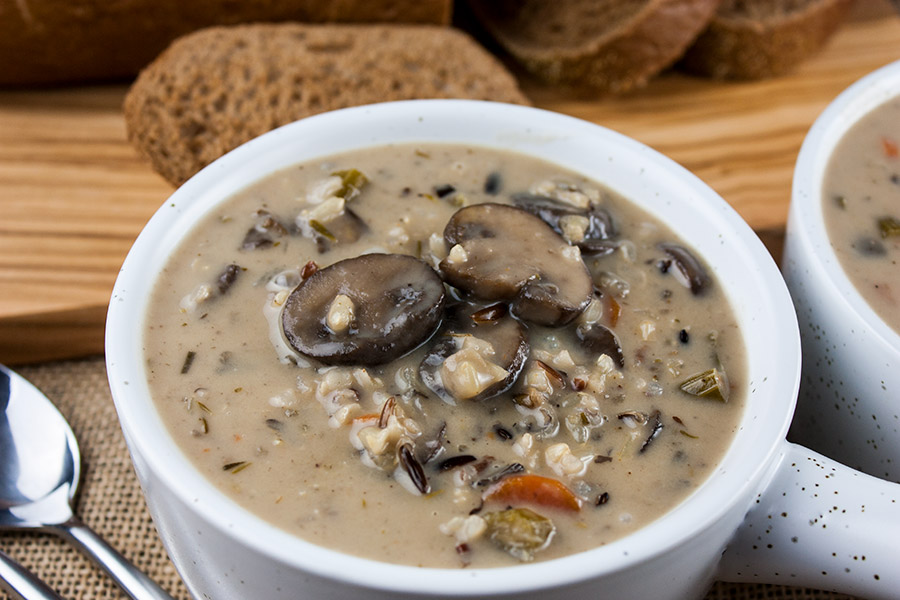 Wild rice and mushroom soup in a white bowl.