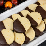 Chocolate orange cookies stacked on white platter