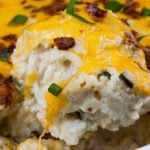 Loaded Cauliflower Mash Casserole with a serving being removed.