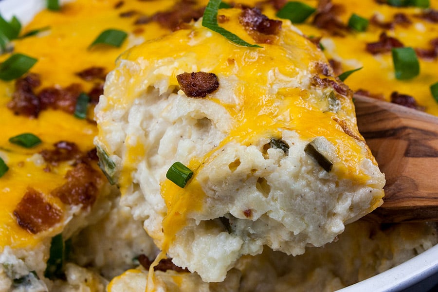 Loaded Cauliflower Mash Casserole with a serving being removed.