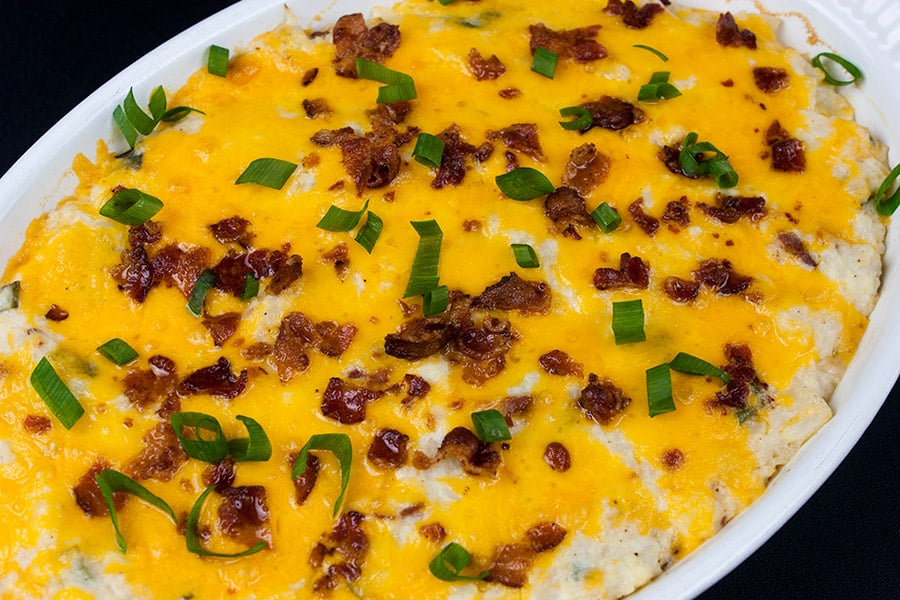 Loaded Cauliflower Mash Casserole baked in a white casserole dish