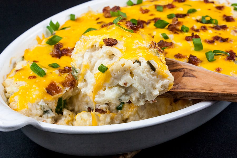 Loaded Cauliflower Mash Casserole - scooped out with a wooden spoon