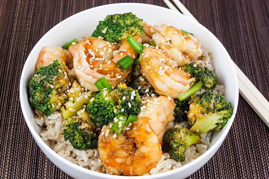 Shrimp and Broccoli Stir Fry in a white bowl with chopsticks