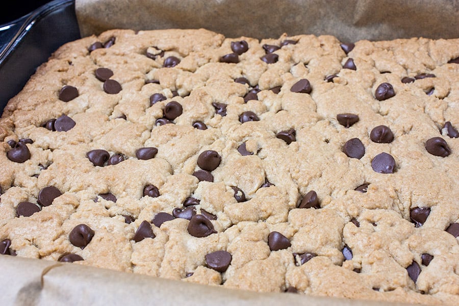 Baked cookie dough in parchment lined baking pan.