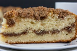 Cinnamon Crumb Coffee Cake - Moist, buttery cake ribboned with a gooey cinnamon middle and topped with a crumbly streusel. Nothing better than a thick slice of this cake with your morning or afternoon coffee.