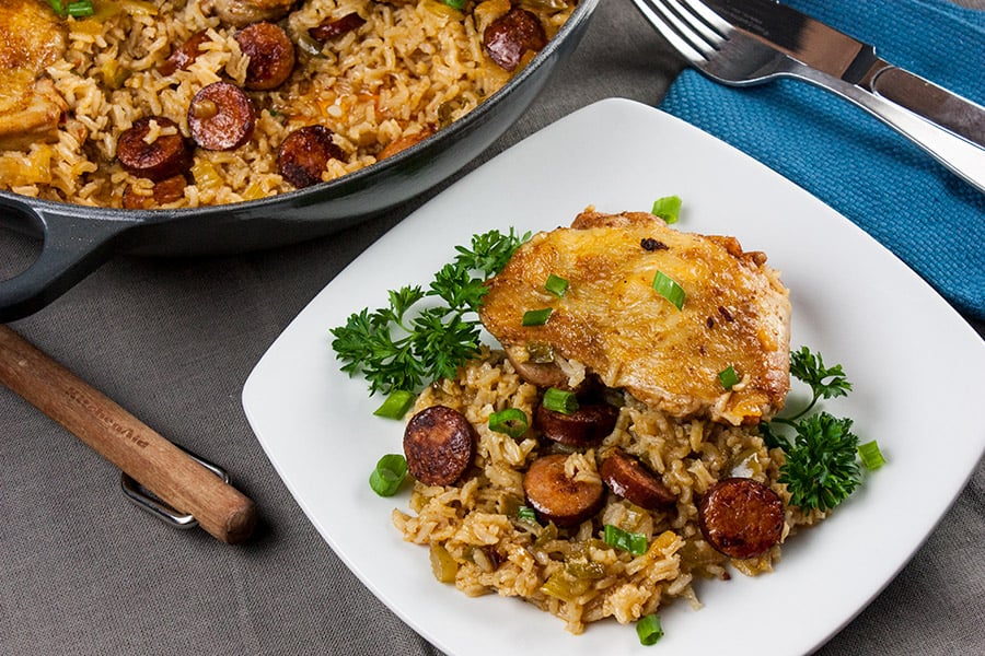 One pan chicken and dirty rice served on a white plate.