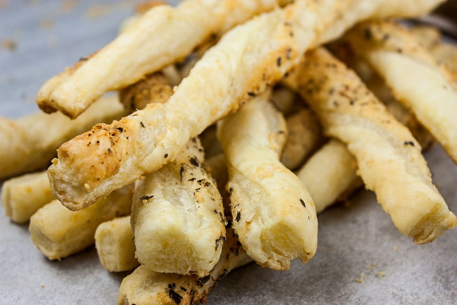 Cheese straws stacked on top of each other.