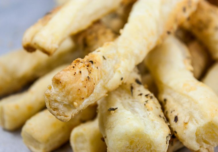 Puff Pastry Parmesan Cheese Straws - Flaky, puff pastry sprinkled with Parmesan Gruyere, garlic, and herbs! You just can't go wrong with this quick and easy appetizer!