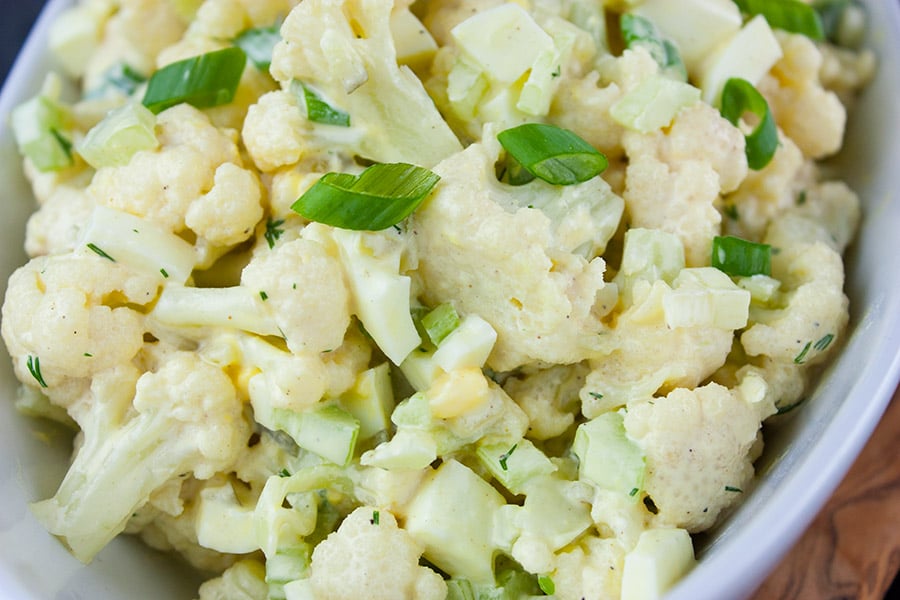 Cauliflower Mock Potato Salad closeup in a white serving bowl