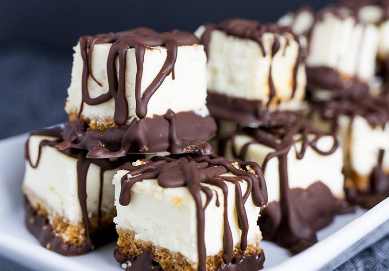 Chocolate Covered Cheesecake Bites - An easy ultimate party treat! A cool, creamy, rich mini cheesecake bite drizzled with chocolate. Perfect for barbecues, holidays or parties of any kind!