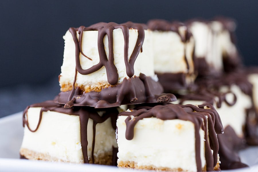 Chocolate Covered Cheesecake Bites - closeup of cheesecake bites on a white platter