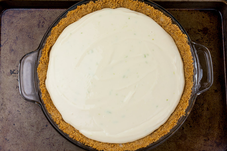 Key Lime Pie mix in a pie pan on a baking sheet.
