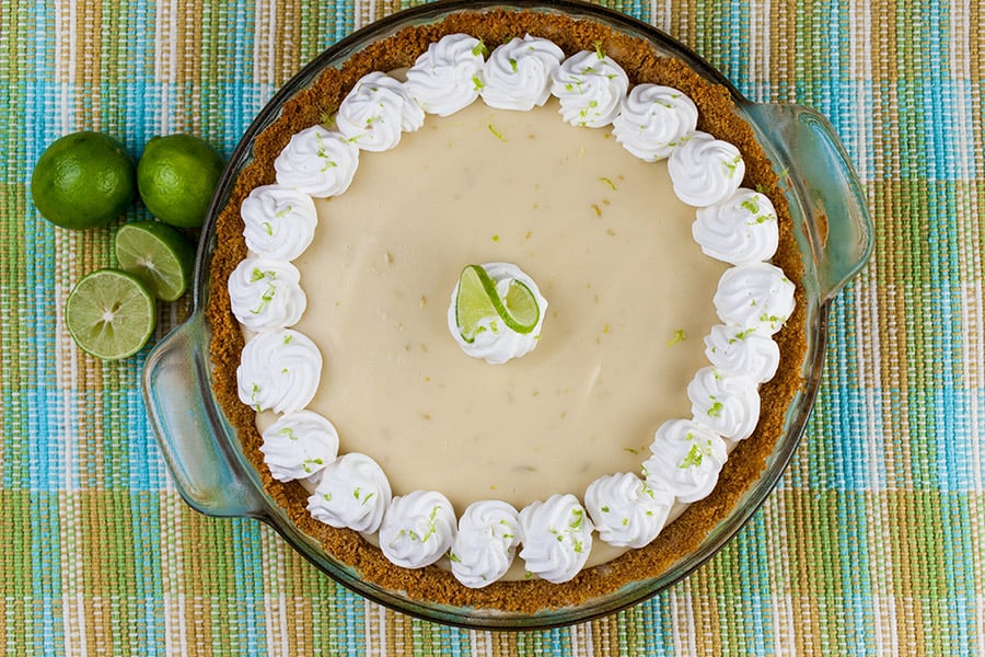 Easy Key Lime Pie garnished with whipped cream and lime slice.