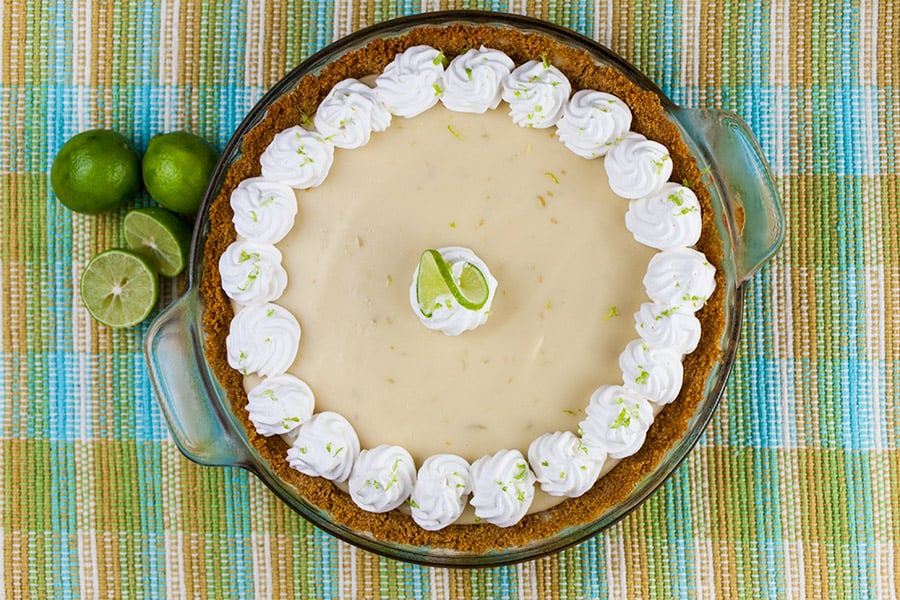 Easy Key Lime Pie garnished with whipped cream and lime slice.