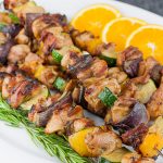 Orange Rosemary Chicken Kebabs on a white platter.