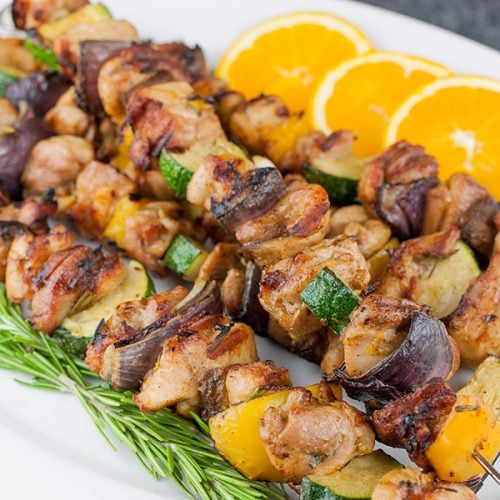 Orange Rosemary Chicken Kebabs on a white platter.