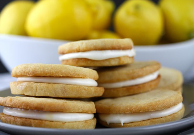 Lemon Sandwich Cookies - Tender, crunchy lemon shortbread cookies sandwiched with a zingy sweet lemon filling. Lemon lovers look no further!