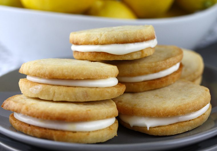 Lemon Sandwich Cookies - Tender, crunchy lemon shortbread cookies sandwiched with a zingy sweet lemon filling. Lemon lovers look no further!