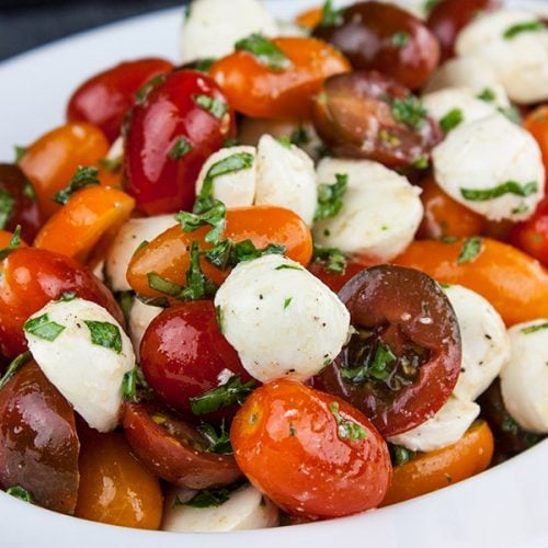 Fresh Tomato Mozzarella Salad in a large white serving dish..