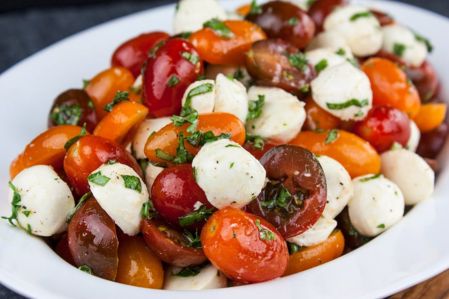 Fresh Tomato Mozzarella Salad in a large white serving dish..