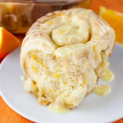 An orange roll on a white plate.