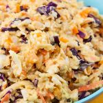 Tangy Southern Mustard Coleslaw in a large blue bowl.