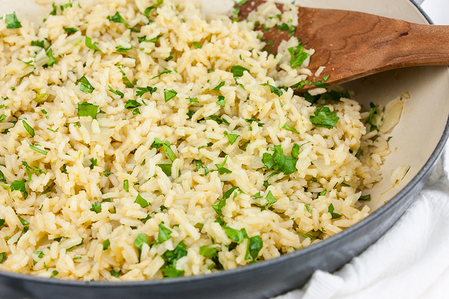 Cilantro lime rice in a gray skillet garnished with chopped cilantro.