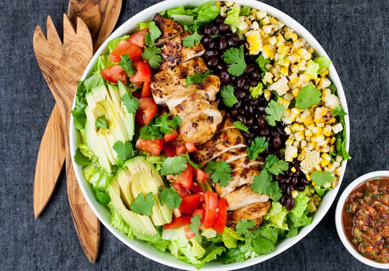 Southwest Grilled Chicken Salad - A fresh, healthy flavorful salad. Chicken marinated in a smoky adobo flavored marinade gives it more than just a "taco" flavor. Grilling the corn and jalapenos adds extra smoky flavor to this dish.