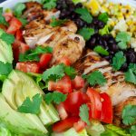 Southwest Grilled Chicken Salad - A fresh, healthy flavorful salad. Chicken marinated in a smoky adobo flavored marinade gives it more than just a "taco" flavor. Grilling the corn and jalapenos adds extra smoky flavor to this dish.