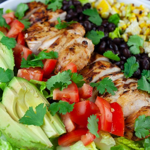 Southwest Grilled Chicken Salad - A fresh, healthy flavorful salad. Chicken marinated in a smoky adobo flavored marinade gives it more than just a "taco" flavor. Grilling the corn and jalapenos adds extra smoky flavor to this dish.