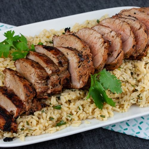Grilled Adobo Pork Tenderloin - Sliced pork tenderloin on a bed of cilantro lime rice.
