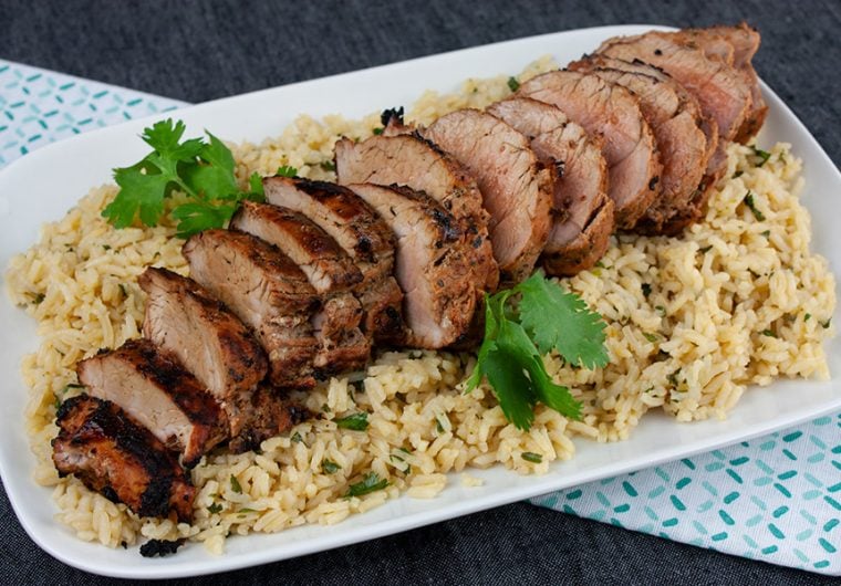 Grilled Adobo Pork Tenderloin - Sliced pork tenderloin on a bed of cilantro lime rice