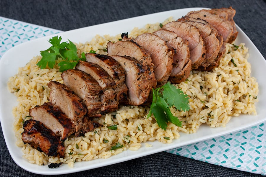 Grilled Adobo Pork Tenderloin - Sliced pork tenderloin on a bed of cilantro lime rice.