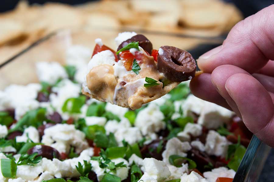 Easy Mediterranean Dip - dip scooped in a pita chip