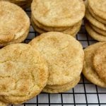 Best chewy snickerdoodle cookies stacked on a wire cooling rack.
