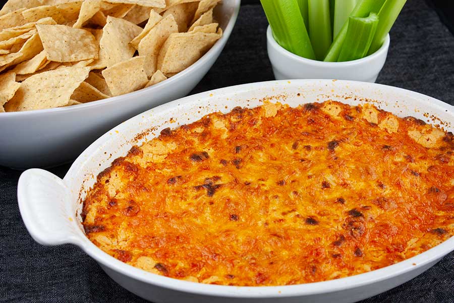 Buffalo Chicken Dip - baked in a white casserole dish