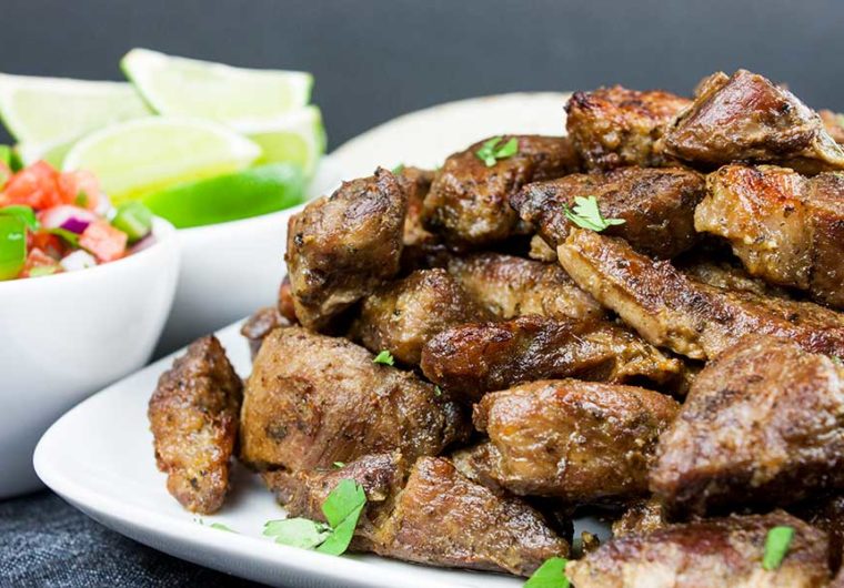 Crispy Pork Carnitas - Slow oven roasted marinated pork cubes with a crispy caramelized crust. Rich, moist, flavorful and so tender it melts in your mouth!