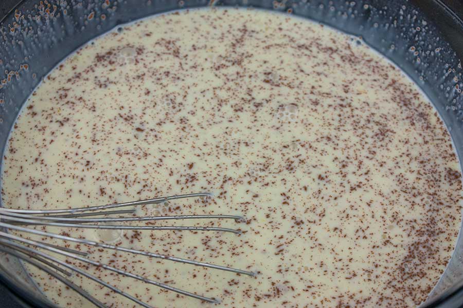 Egg mixture in a glass mixing bowl.