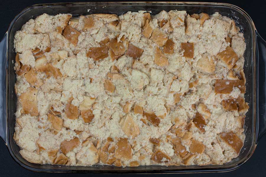 Bread pudding mixture in a glass baking pan ready to sit overnight.