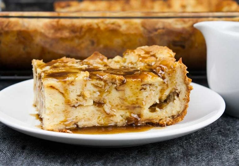 Bread Pudding with Bourbon Sauce - Moist, dense yet light, kissed with classic spice flavor. This bread pudding is decadence at it's best! The bourbon sauce makes it over-the-top indulgent!