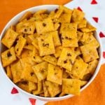 Firecracker Cheez-Itz in a white bowl on an orange table cloth.