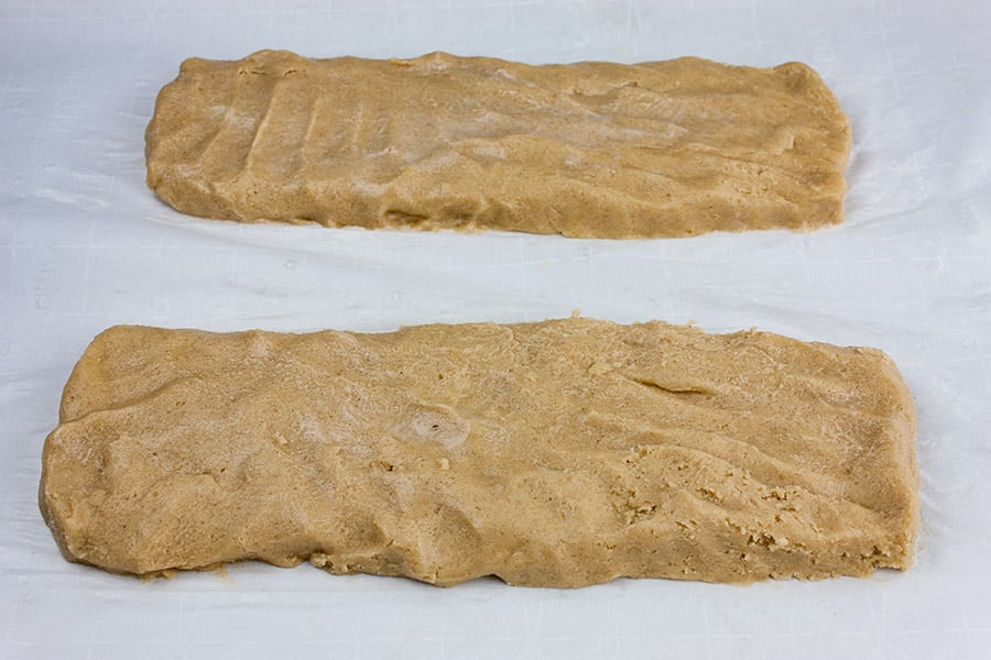 Spiced Apple Cider Biscotti dough formed into two logs on parchment paper 