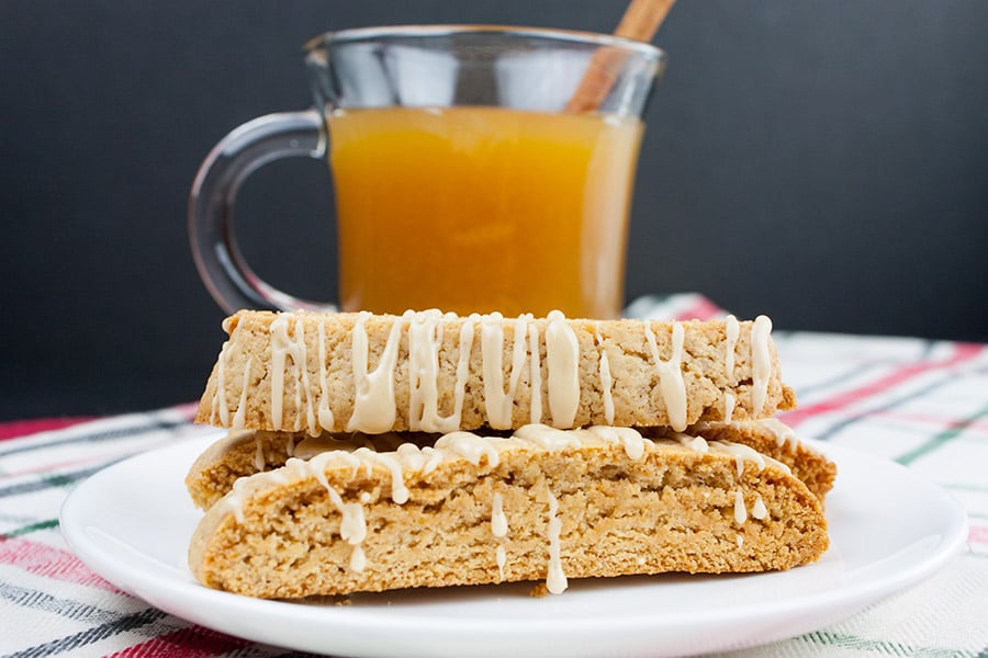 Spiced Apple Cider Biscotti - biscotti on a white plate with a glass mug of hot apple cider