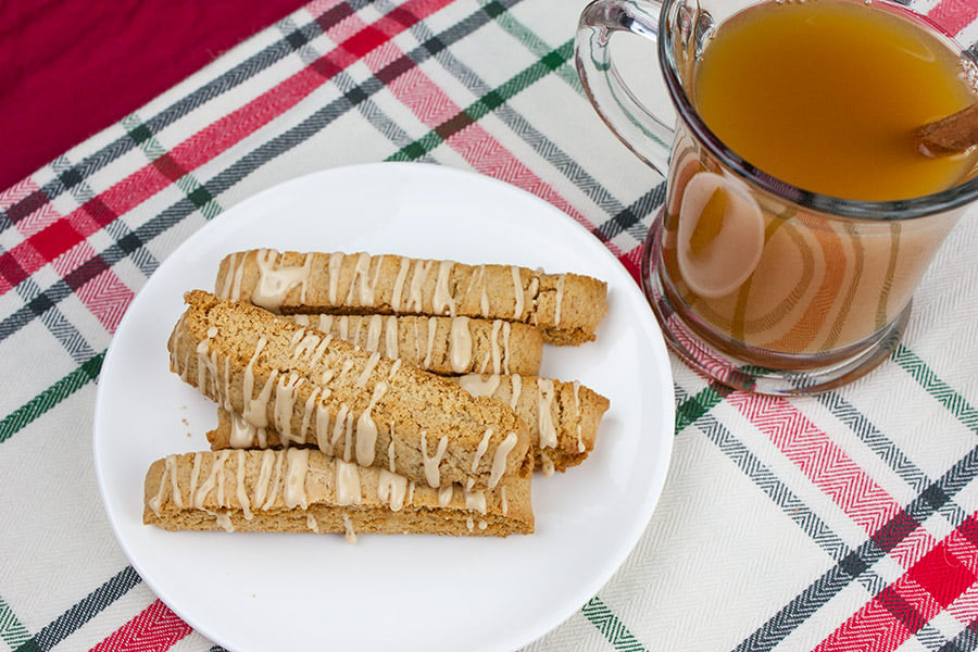 Spiced Apple Cider Biscotti - biscotti on a white plate next to a glass mug of hot apple cider
